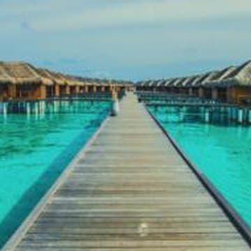 Overwater villas on a turquoise lagoon